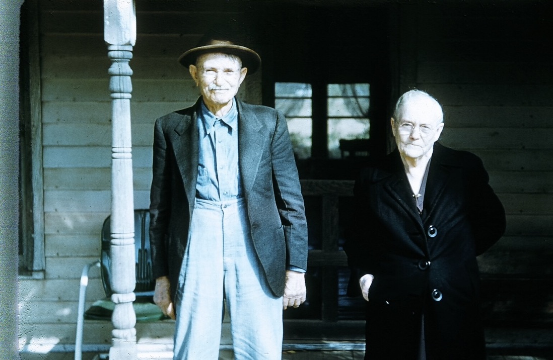 A couple of old men standing outside
Description automatically generated