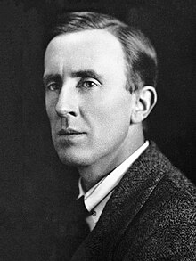 Black-and-white portrait photograph of J.R.R. Tolkien from the chest up, wearing a tweed jacket, waistcoat, and tie.