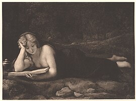 A sepia-toned print shows a nude woman lying on her stomach in a wooded landscape, propped on one elbow reading an open book, with a small oil lamp beside her.