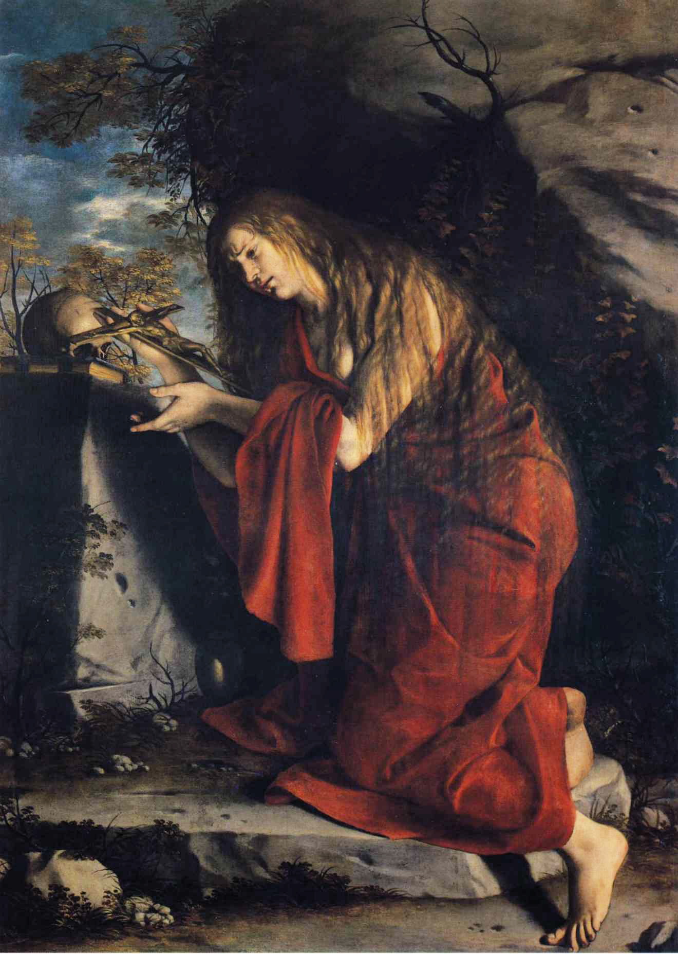 A painting shows a woman in a red robe kneeling in a rocky grotto, reaching toward a small crucifix propped beside a skull and draped white cloth, with trees and sky visible at left.